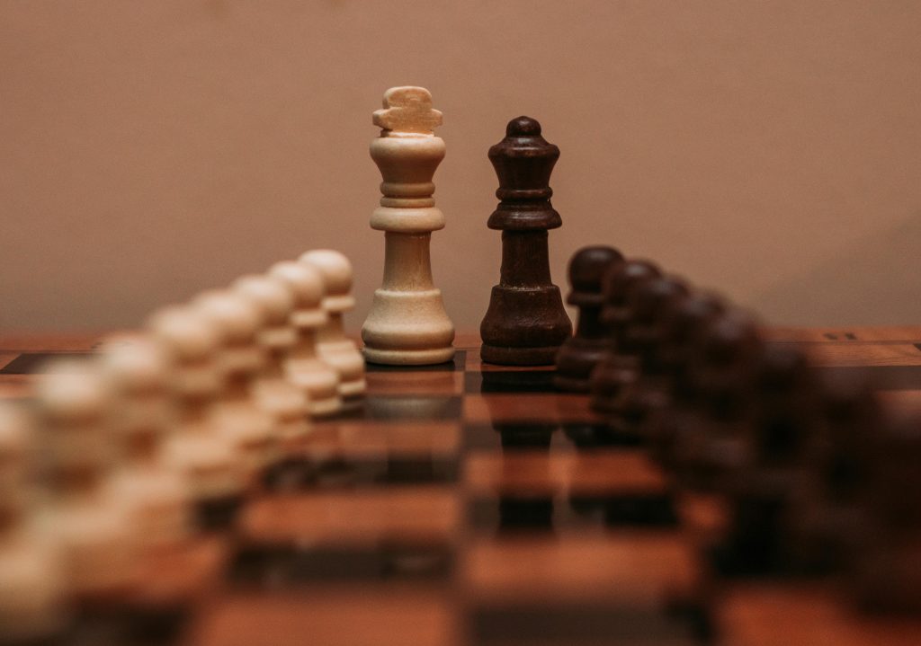 Focused view of chess pieces on a board, showcasing strategy and intellect in a classic game.
